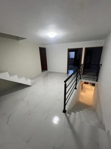 an empty room with a staircase in a building at Casa Analco Durango in Durango