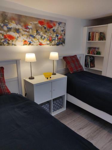 a bedroom with two beds and a painting on the wall at Haus-Salamander-mit-Sauna in Wildemann