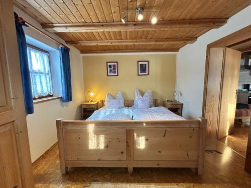 a bedroom with a bed with white sheets and pillows at Niedermaier Hof in Bad Birnbach