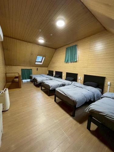 a row of beds in a large room at Modern style old house in Nagoya