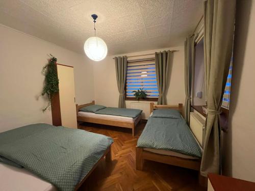 a room with two beds and a window at Apartmán Renata in Rudník