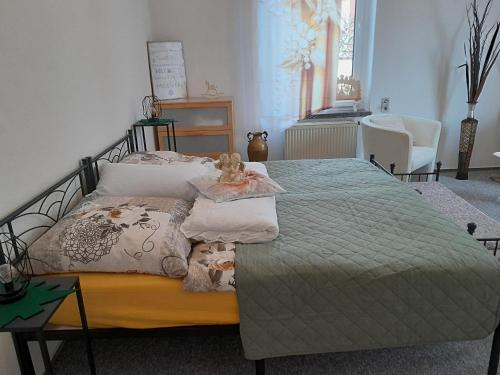 a bedroom with a bed with a teddy bear on it at Ferienwohnung Springstein in Aue