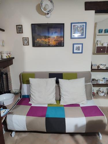 a bed with a colorful blanket on it in a room at LA BICO' in Pitigliano