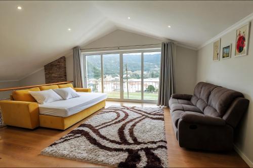 a bedroom with a bed and a couch at Home In Green Caldera in Furnas