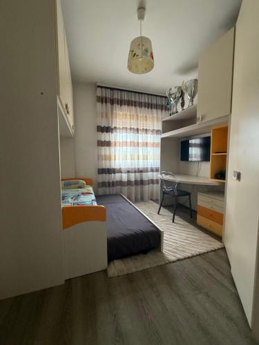 a bedroom with a bed and a desk in a room at Appartamento Venezia in Marghera