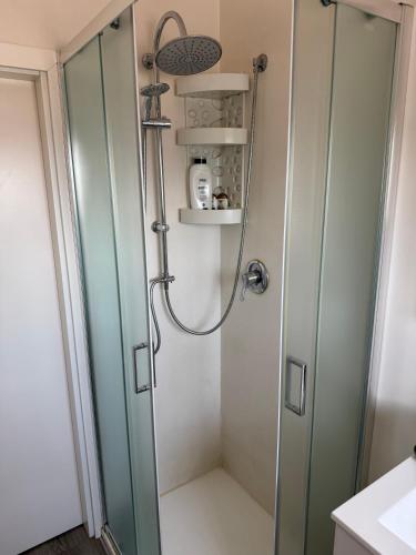 a shower with a glass door in a bathroom at Appartamento Venezia in Marghera