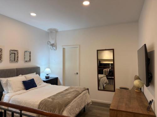 a bedroom with a large bed and a mirror at Charming and Relaxing Home in Guatemala