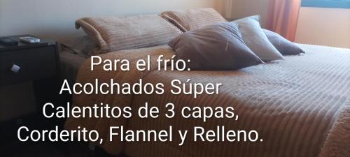 a bed in a bedroom with a quote about a bed at Vergniaud 70 in Colón