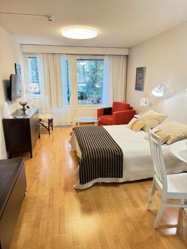 a bedroom with a bed and a living room at Kylpylä-hotelli 261 in Ikaalinen