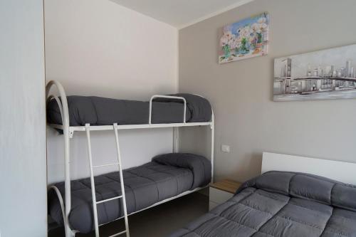 a bedroom with two bunk beds in a room at Il Vecchio Pozzo Apartments in Ostigliano