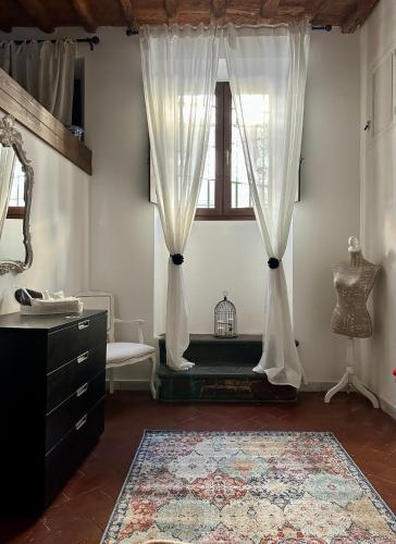 a room with a window with curtains and a table at Live As Florentine in Florence