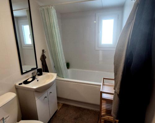 a bathroom with a tub and a sink and a bath tub at Sauna v lese in Uhrovec