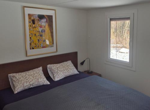 a bedroom with a blue bed and a window at Sauna v lese in Uhrovec