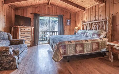 a bedroom with a bed and a television in a cabin at Mountain View Cabins in Tellico Plains