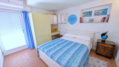 a small bedroom with a bed and a window at Villa Vista Lago con Jacuzzi e Campo Volley in Monte del Lago