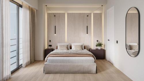 a bedroom with a large bed and a mirror at Athesense Suites in Athens