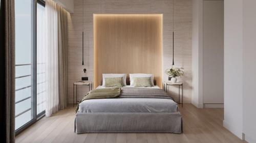 a bedroom with a bed with two side tables at Athesense Suites in Athens