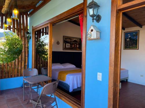 a bedroom with a bed and a table and chairs at Casa del Abuelo in San Pedro La Laguna