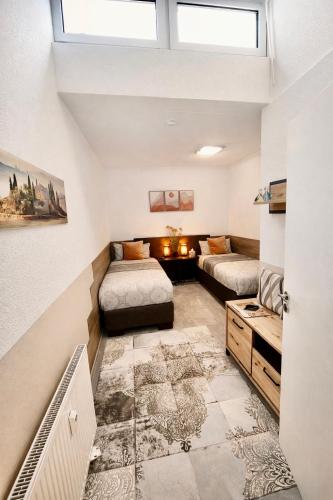 a living room with two beds and a couch at 2 Room Galerie Einliegerwohnung in Rheinstetten, Messe Nähe, Rollstuhlfahrer geeignet in Rheinstetten