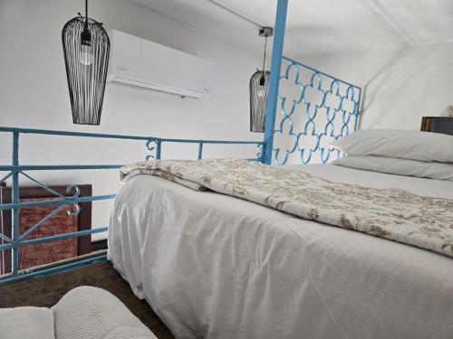 a bed with a blue headboard in a room at Colonial apartment for up to 4 person in Santo Domingo