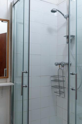 a bathroom with a shower with a glass door at Studio apartment next to Highgate tube station in London