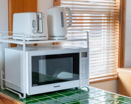 a microwave sitting on top of a counter at Studio apartment next to Highgate tube station in London