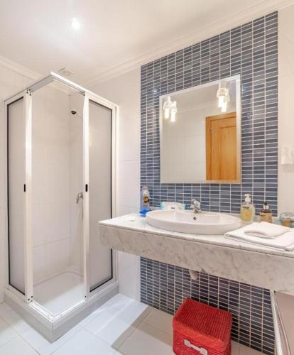 a bathroom with a sink and a shower at Vista Calheta Apartment in Calheta