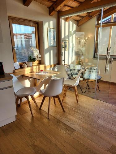 a kitchen and dining room with a table and chairs at Suites DANICA in Šmartno