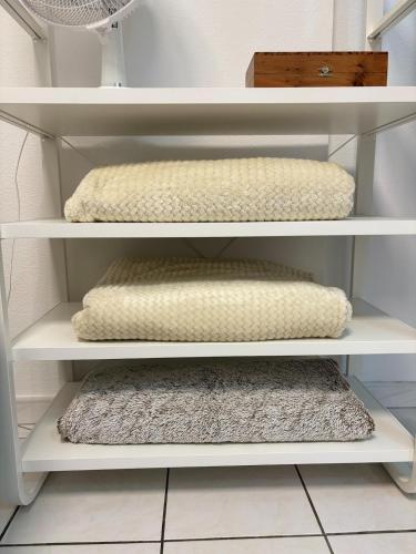 two white shelves with pillows on them in a room at Charmant Duplex - Hyper Centre - 44m2 - Proche Place Stanislas in Nancy