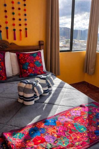 a bedroom with a bed with flip flops on it at Casa Josvic in San Cristóbal de Las Casas