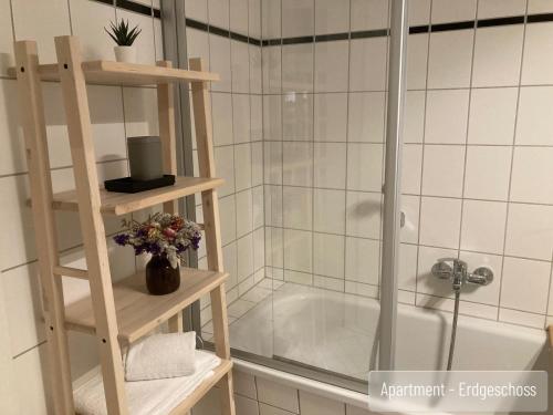 a bathroom with a shower and a bath tub at Anno 1577 - Marktkirchhof 6 in Quedlinburg