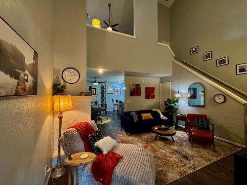 a living room with a couch and a table at Gated Lakefront Retreat in Edmond