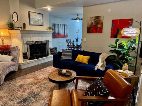 a living room with a blue couch and a fireplace at Gated Lakefront Retreat in Edmond