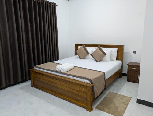 a bedroom with a large bed with brown curtains at Coco Haven in Habaraduwa Central