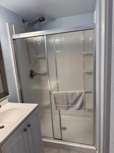 a shower with a glass door in a bathroom at Ocean Dream in Kitty Hawk Beach