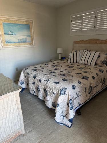 a bedroom with a bed and two dogs sitting on the floor at Ocean Dream in Kitty Hawk Beach