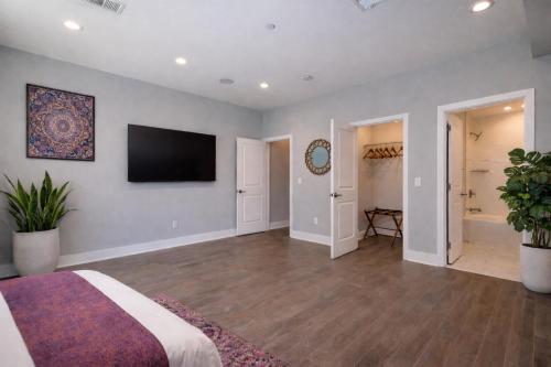 a bedroom with a bed and a television on a wall at Artsy Hidden Gem ll -Free Parking --- in Philadelphia