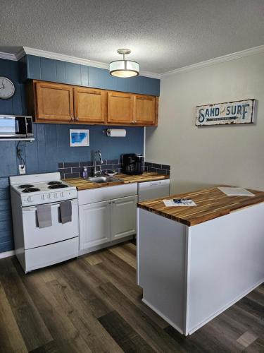 a kitchen with a white stove and a sink at BEACHSIDE CONDO-WATER AND POOL VIEW Top Floor in Tybee Island