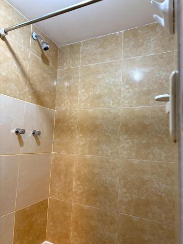 a bathroom with a shower with a glass door at Cusco - Flor de Loto in Cusco