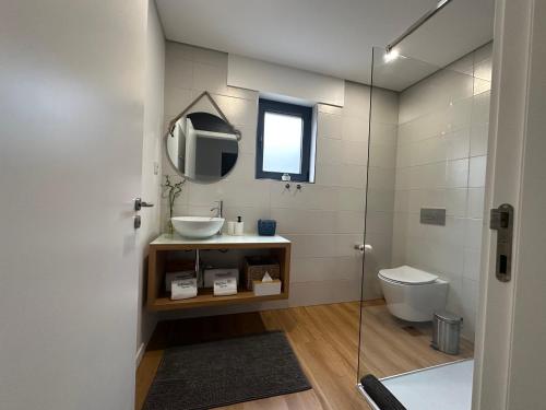 a bathroom with a sink and a toilet at Ri&Vale Alojamentos in Vieira do Minho