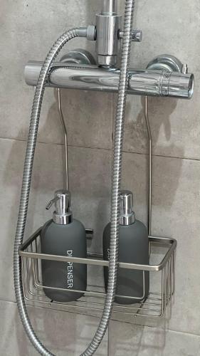 two soap dispensers on a shelf in a bathroom at AMMO in Olhão