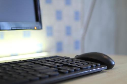 a computer keyboard and mouse sitting on a desk at Hotel 1000 Miles in Kuala Lumpur