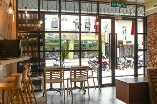 a restaurant with a bunch of chairs in front of a window at Hotel 1000 Miles in Kuala Lumpur
