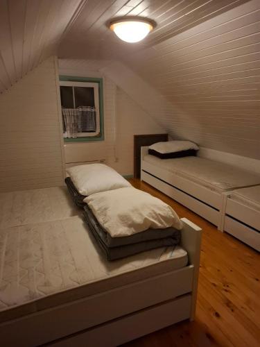 a small room with two beds in it at Brunarica Beti in Brežice