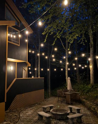 a patio lit up at night with lights at Blackwood Cabin Pocono in Pocono Farms East