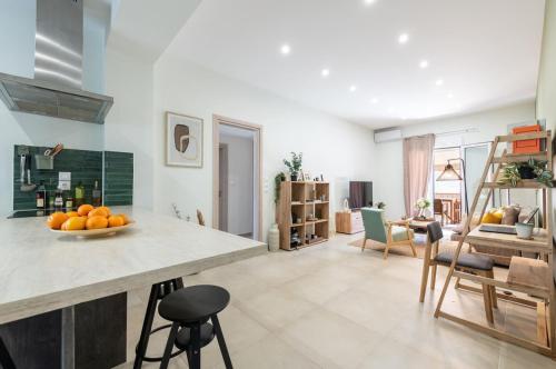 a kitchen with a counter with a bowl of oranges on it at Kypseli Authentic Flat in Athens