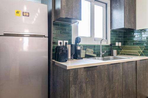 a kitchen with a refrigerator and a sink at Kypseli Authentic Flat in Athens