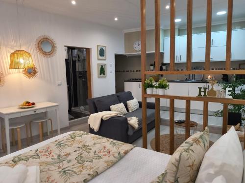 a room with a kitchen and a living room at Lucas House in Nazaré