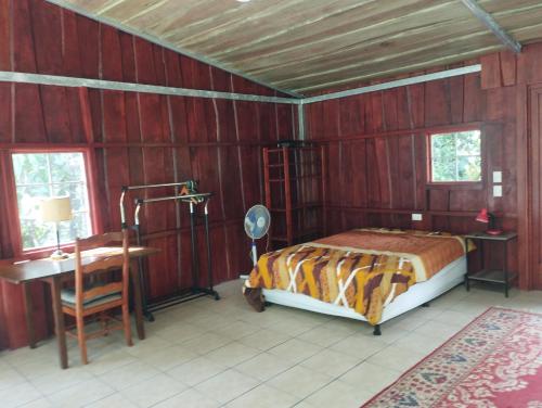a bedroom with a bed and a desk and a table at Maison tranquille in Rivas