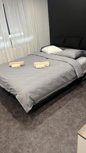 a large bed with two pillows on top of it at Apartman Tango in Zaprešić